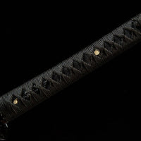 Black sword with decorative handle on a black background