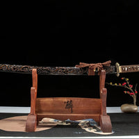 Sword on a wooden stand with a dark background