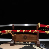 Sword with red sheath on a wooden stand against a black background